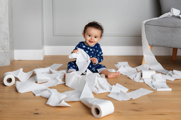 Cute baby playing with toilet paper