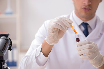 Chemist in the lab checking with ph strips