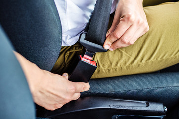 Car seat belt fastening close-up. Driving safely.