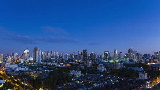 Stationary Bangkok cityscape time-lapse transition from dark to morning dawn, sunrise then blue sky day of city skyline and downtown high-rise buildings along Sukhumvit Road. 16:9 4k at 30fps