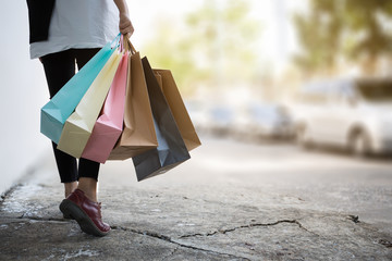 Close up of woman hand holding shopping bags.