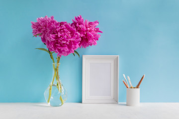 Mockup with a white frame and pink peonies