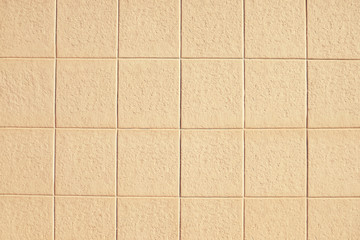 Old beige mosaic wall background texture