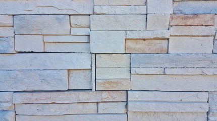 A wall made from slate stone showing rough surface and interesting textures.  