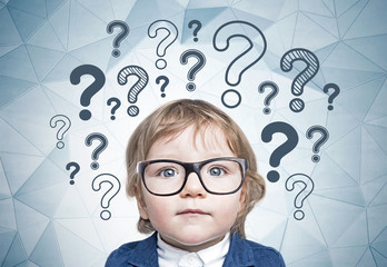 Cute little boy in glasses, many questions