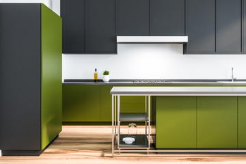 White kitchen, black and green counters, fridge
