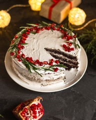 chocolate cake with pomegranate and rosemary (the cake is creamy with chocolate). top view.