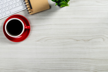 Workspace with computer, colour pencils and coffee mug on white background. Flat lay, top view