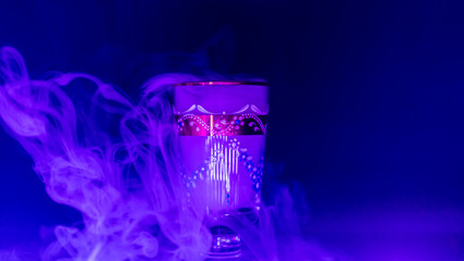 goblet glass full of smoke, goblet glas filled with smoke, smoke inside a glas, blue colour image of a glass filled with smoke