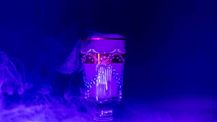 goblet glass full of smoke, goblet glas filled with smoke, smoke inside a glas, blue colour image of a glass filled with smoke