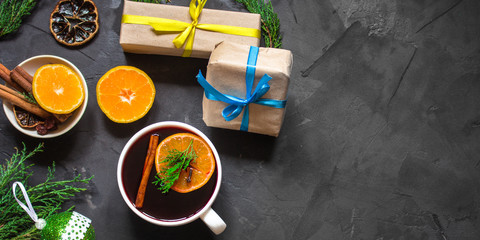 Mulled wine with spices and gifts on the table. Happy New Year! Top view