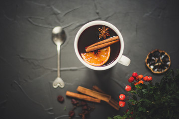 Mulled wine with spices and gifts on the table. Happy New Year! Top view