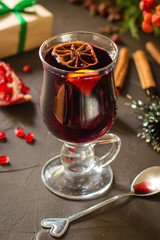 Mulled wine with spices and gifts on the table. Happy New Year! Top view