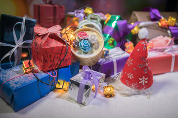 Christmas gift or New Year with blue ribbon on rustic wood table on bokeh background. Handmade gift concept.