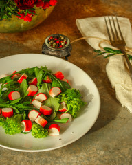 fresh salad lettuce leaves and crab sticks. top view. copy space