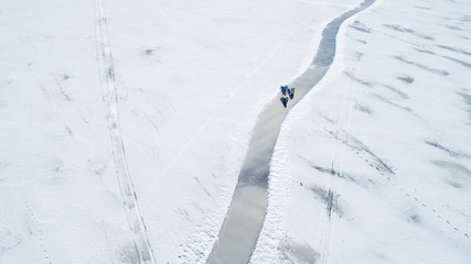 People skating on a frozen lake in winter