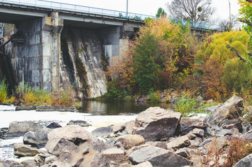Fototapeta na wymiar Closed sluices at the old small dam