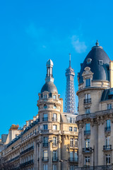 Paris, beautiful buildings, typical facades, with the Eiffel Tower in background 