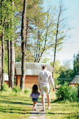 Fototapeta premium family with a little girl on nature in summer