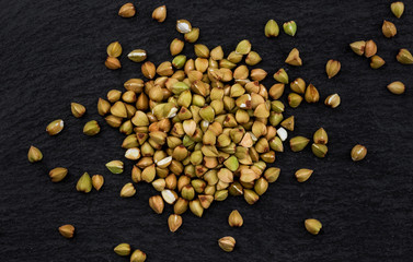 Green buckwheat on black background. Top view