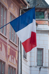 closeup of french flag on building facade in Mulhouse place