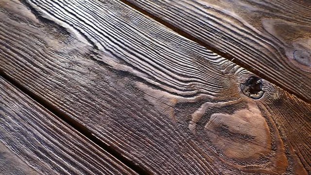 The texture of the wooden board. Old wooden table. An ancient relic. Dark background.