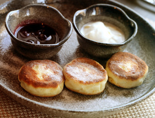 Macro photo of delicious bright cheese cakes with jam and sour c