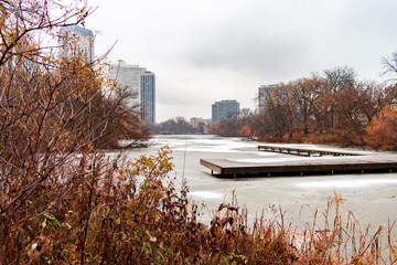 North Pond in Lincoln Park Chicago Surrounded by Plants and Trees in late Autumn with Snow and Ice