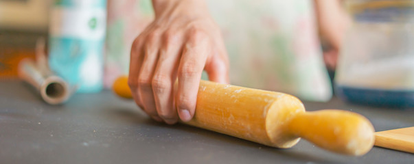 close up chef hands holding rolling pin and preparing food f