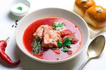 Borscht, Red Soup Made of Beetroot and Vegetables with Pork Ribs and Sour Cream Served with Garlic Rolls, Ukrainian, Russian and Polish Traditional Dish