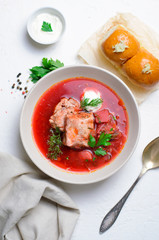 Borscht, Red Soup Made of Beetroot and Vegetables with Pork Ribs and Sour Cream Served with Garlic Rolls, Ukrainian, Russian and Polish Traditional Dish