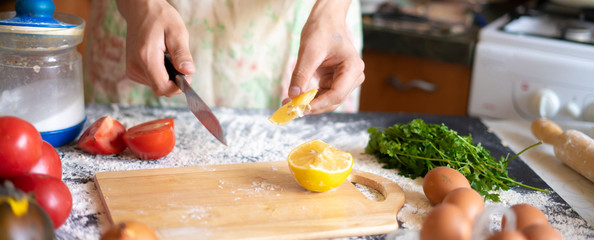 close up crop image of chef cook cut lemon in the kitchen f