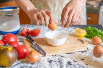 male cook baker hands break egg while food preparation f