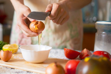 male cook baker hands break egg while food preparation f