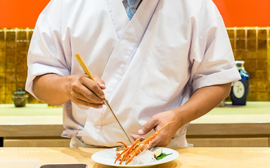 chef cooking lobster sashimi