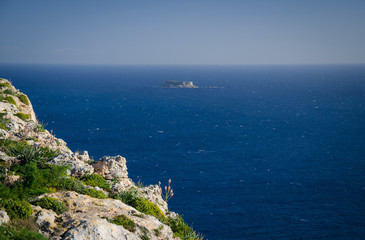 Fototapeta na wymiar View of limestone rock, Mediterranean sea and Filfla island, Malta