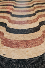 wavy mosaic formed by marble tesserae
