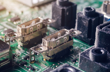 A thick layer of dust covers the internal electronic components of the computer