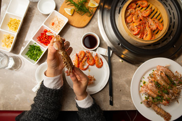 Enjoying chinese style steamed seafood. Studio photos without face. 