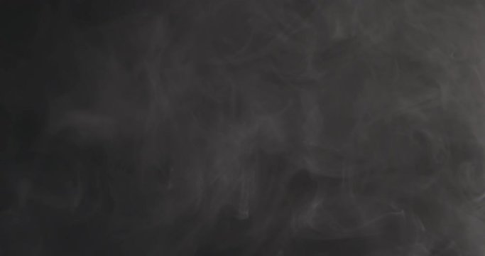 Slow motion closeup vapor floating in air on black background