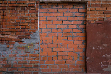 A fragment of a red brick wall at an idle factory,shot in late autumn
