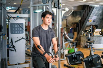 Fototapeta na wymiar Asian man exercising at gym.