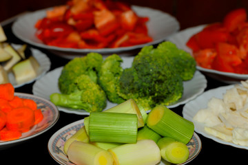 Various dishes with different vegetables chopped