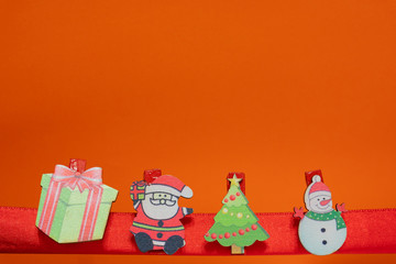 Christmas ornaments decorations on the red ribbon with gift boxes, snowman