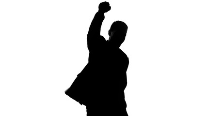 Businessman silhouette raises fist up, celebrates success, proud of achievement