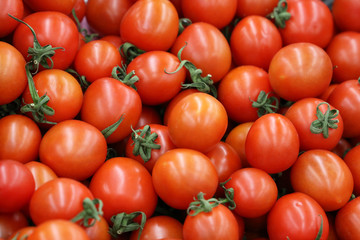 Red cherry tomatoes background. Group of fresh tomatoes