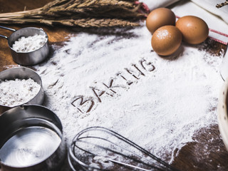 Pastry Baking Accessories Bakery Background with baking text writing on flour. Ingredients for the preparation of bakery products.