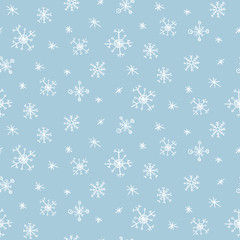 Cute vector seamless pattern with hand drawn white snowflakes on light blue background. Tender winter texture for textile, wrapping paper, wallpaper, new year decor