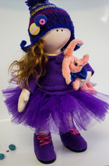 beautiful handmade doll in purple clothes