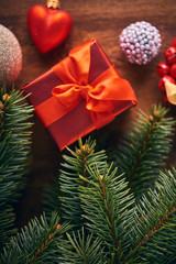 Christmas background. A lot of red vintage baubles, gift box and fir tree